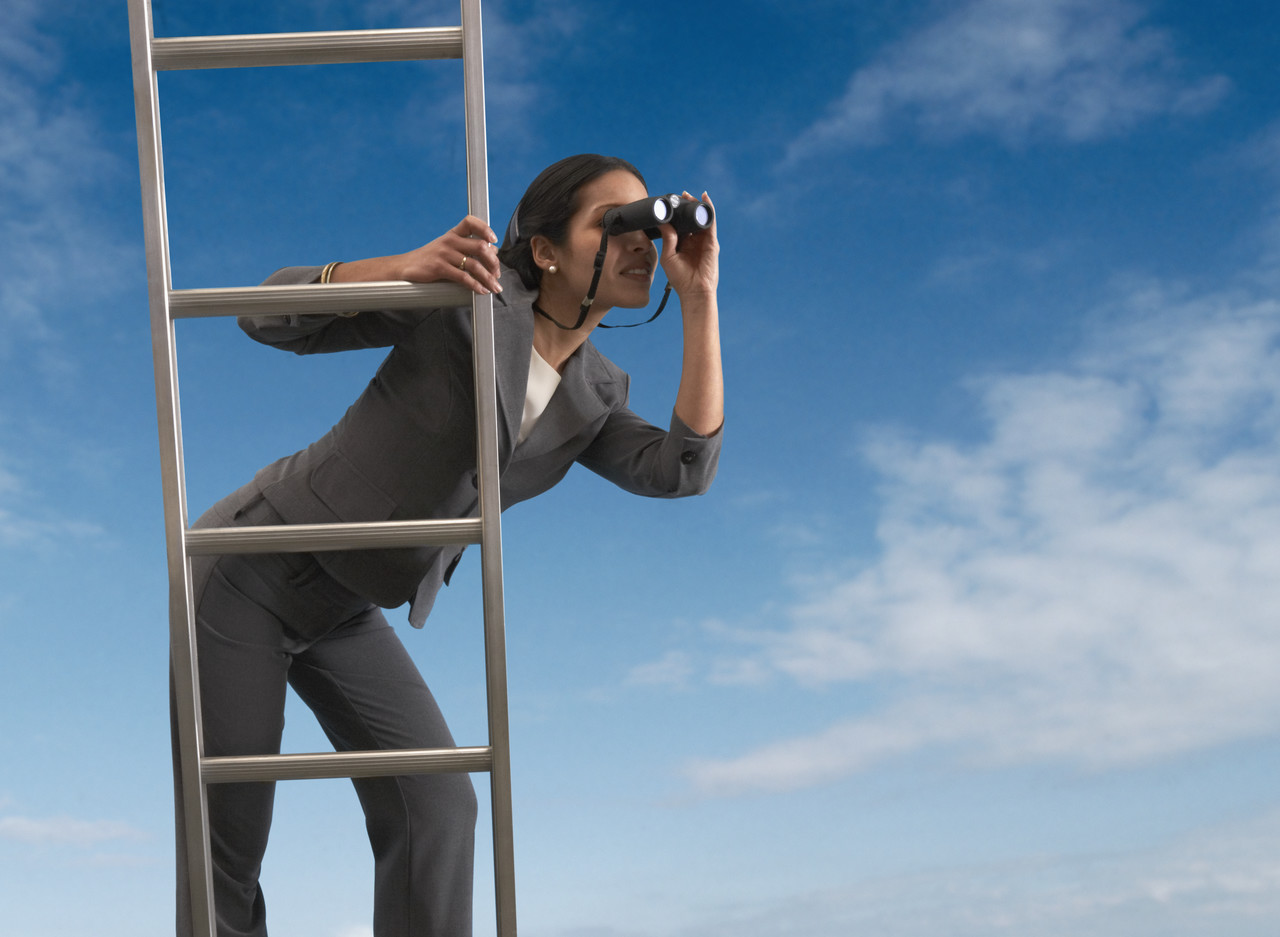 Woman on ladder looking through binoculars